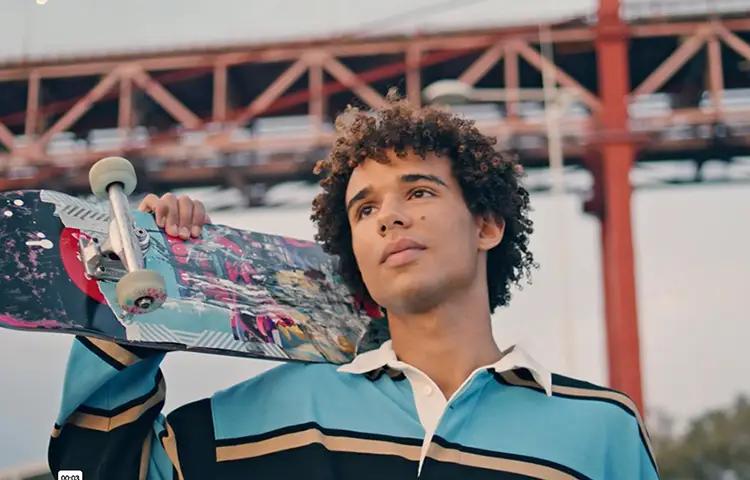 a young man holding a skateboard